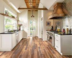We Love The Flow Of This Galley Kitchen With Global Reclaim Worldy Hue Laminate Flooring Brown Laminate Flooring Farmhouse Kitchen Design Kitchen Remodel