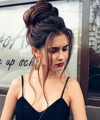 Curl your long locks with the help of the thick iron, upswept one part of the hair, twist locks and use pins with flowers to fix the hairstyle. Beautiful And Elegant Homecoming Bun Hairstyles Long Hair Top Knot Bun Hairstyle Ideas Bun Hairstyle Formal Wear It Style