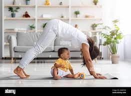 young mom and son practice yoga at home. Sporty mother with child  exercising in the morning. Mom and son do the exercises together, a healthy  family l Stock Photo - Alamy