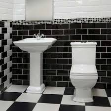 The black window frame continues the theme, while the tub and mirror add a gold accent that's a popular choice for black and white spaces. Home Architec Ideas Bathroom Design Black And White Tiles