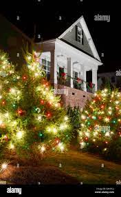 Red Green And White Christmas Lights Outdoor Christmas Trees Have Been Decorated With Red Green And White Lights And Shot Against A Victorian Style Home Stock Photo Alamy