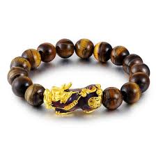 This tiger eye beaded bracelet with a touch of gold is the men's beaded bracelet to have with you when there is an important decision to be made, as the tiger eye stone will balance your inner self and you will accept whatever life throws at you. Tiger Eye Mens Thermochromic Pi Xiu Wealth Bracelet Zenheavens