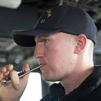 US Navy 110620-N-OS574-192 Boatswain's Mate 3rd Class Alfred Thomas gives  the signal to drop anchor aboard the San Antonio-class amphibious transpo