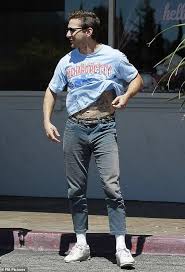 Shia Labeouf Lifts His Shirt To Show Off Creeper Tattoo Across The Star S Belly Polytrendy Mens Outfit Inspiration Mens Outfits Japanese Mens Fashion