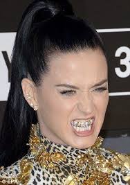 A mouth that Roars! Katy Perry wears diamond encrusted grill promoting hit  single as she makes an entrance at the MTV VMAs
