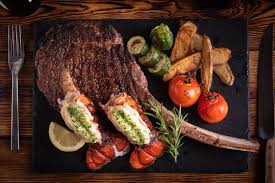 Rib eye steak lobster tail and asparagas. Surf And Turf With Tomahawk Rib Eye Steak And Lobster Tail Stock Foto Adobe Stock