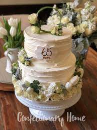 Buttercream 65th Anniversary Cake With Fresh Flowers In White And Pale Green And A Floral Wreath Topper Fresh Flower Cake Cake Bakery Menu