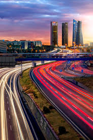 View on crossroads the gran via and calle de alcalá. Sunset Madrid Skyline Domestika