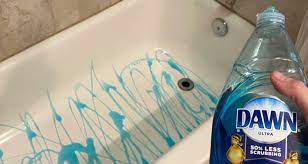 Cleaning bathtub with washing powder. Clean Bathtub With A Broom And Dish Soap Simplemost