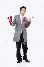 Male Asian In Suit Posing In A Studio With Cupid Arrows Stock Photo,  Picture And Royalty Free Image. Image 85443989.
