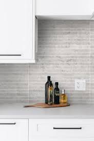 By bringing the backsplash from the countertops to the ceiling, the designer created a sizable accent wall that appears as if it was carved right out of the earth. 37 Gray Kitchen Backsplash Tiles Gray Tile Ideas Gray Tile Backsplash Gray Kitchen Backsplash Kitchen Backsplash