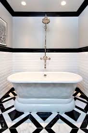 Absolutely stunning bathroom design with gray paneled walls and polished nickel curtain rod holding floor length gray draperies adorning incredible black leaded glass french doors opening to a delightful balcony. Jeff Finishes Gramercy Before And After Jeff Lewis Design Bathtub Remodel Black White Bathrooms