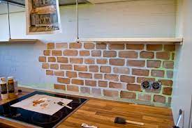 We're used to seeing subway tile backsplashes, but this brick version is a bit more out of the ordinary. Remodelaholic Tiny Kitchen Renovation With Faux Painted Brick Backsplash
