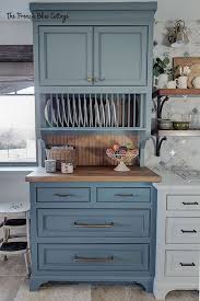 A large island features a finish in a blue shade, turned corner columns, glazed cabinets, a rectangular top in mid browns. Creating Our Dream Kitchen French Country Kitchen Reveal French Blue Cottage