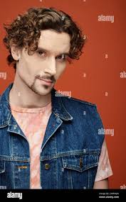 Close up capture of an Caucasian man hands holding and old feng shui coin.  Lucky Chinese Fortune new years cake coin Stock Photo