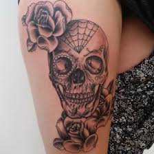 A big tattoo on chest with a skull in the crow's talons and in the middle of compositiona and two roses on both sides. 31 Supreme Skull Rose Tattoos Gun Candy