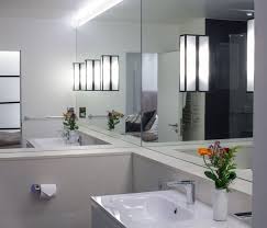 This versatile piece is designed to match many bathroom styles. 10 Rooms With A Mirrored Wall Minimalist Bathroom Bathroom Mirror Design Mirror Wall Bathroom