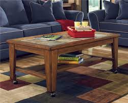Toscana Rectangular Cocktail Table With Casters By Signature Design By Ashley Gardiners Furniture Coc Coffee Table Living Room Table Sets Coffee Table Wood