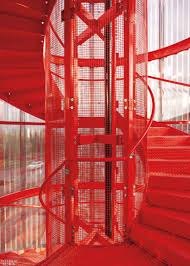 Mk Gallery S Spiral Fire Escape Stairs Is Surrounded By Perforated Painted Steel Gallery Design Architect Architecture
