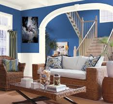 A modish living room with a luxurious brown sofa set and a stylish fireplace. Blue And Brown Living Room Ideas