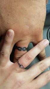 Infinity They Had Their Rings Customized The Man Had It Bolder While The Lady Had It Finer T Tattoo Wedding Rings Wedding Band Tattoo Ring Tattoo Designs