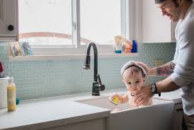 Cute baby taking bath in kitchen sink. Top 10 Baby Bathing Tips Kitchen Sink Baby Bath