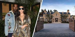 One bedroom has a huge bed with cream headboard and white bedding, and wooden bedside tables on either side. Kim Kardashian West S Vogue Interview Reveals The Star S House Has Two Kitchens