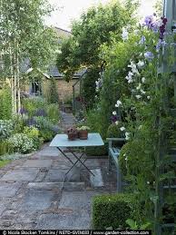 By Screening The Boundaries With Lush Planting You Make The Garden Seem Far Bigger Outdoor Gardens Garden Small Gardens