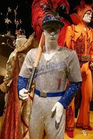 Rocketman opens with elton john (played by taron egerton) leaving the stage in a dramatic, bejeweled devil costume and then promptly entering group therapy to deal with his personal demons. Elton John Rocketman Dodgers Baseball Costume Elton John Costume Elton John Baseball Costumes