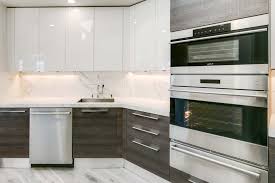 The grey shaker cabinets, light tile floor, and white countertop all have similar color tones. Everything You Need To Know About Under Cabinet Lighting