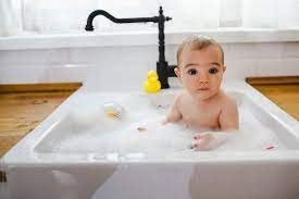 In addition, wet babies are very slippery and i always found it easier to bathe kidlet in a baby tub. Baby Having A Bath In The Kitchen Sink By Dejan Ristovski