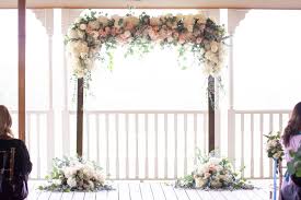 We love how one side of the wooden a circular arch gives a different dimension to a flower arch. Wedding Arch Flowers Ideas Ten Point Floral Design