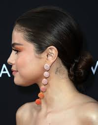 Flower behind the ear tattoos. What Do All Of Selena Gomez S Tattoos Mean Popsugar Beauty