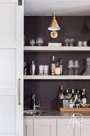Hidden Bar With Sliding Door And Floating Shelves Lining A Black Grasscloth Backsplash Transitional Home Wet Bar Kitchen Wall Lights Home