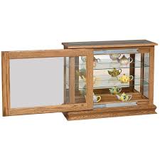 Introduced in the 16th century, curio cabinets were used to display objects invoking curiosity. Deluxe Console Corner Curio Cabinet From Dutchcrafters Amish Furniture