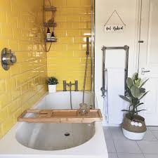 Neutal Bathroom With Yellow Tile Pop Of Color Lights Is Up Bathtub With Updated Accessories Adds Modern To Retro Look Pop Yellow Bathrooms Home Yellow Tile