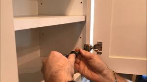 Unscrew two screws on each side, on the inside of the horizontal face frame across the front. Do It Yourself How To Adjust Cabinet Door Hinges Step By Step Youtube
