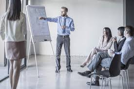Businessman Leading A Presentation With Flip Chart Young