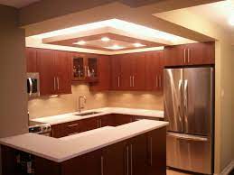 Tray ceilings frame a room and give an impression of a higher ceiling with the two layers. G Shaped Kitchen And Kitchen Cabinet Also Kitchen Ceiling Designs Kitchen Ceiling Design Kitchen Ceiling Kitchen Lighting Fixtures Ceiling