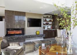 This large coffee table features a shapely chrome frame, heavy glass top with beveled edge, and makes an impressive addition to any seating area. Sleek Contemporary Living Room With Gray Stone Fireplace Surround Glass Coffee Table And Mixed Seating Options Hgtv