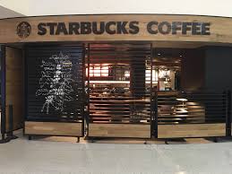 Branded Wood Starbucks Coffee Look Painted Along The Top With Botanical Painted On Wood Slats At The Louisville Airport Www Cafe Design Design Starbucks Shop