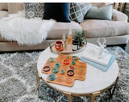 Choose pretty containers or baskets to store books, magazines and remotes on the second tier of the coffee table. Winter Coffee Table Vignette Ideas The Naptime Reviewer