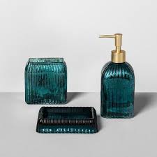An oversized map pops against the emerald wall, while new tiles and fixtures pull the look together. Glass Soap Lotion Dispenser Teal Blue Opalhouse Teal Bathroom Decor Teal Bathroom Accessories Gold Bathroom Decor