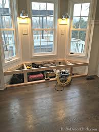 The bright red makes this area a focal point against the crisp white cabinetry and trim. Bay Window Seat In The Kitchen Thrifty Decor Chick