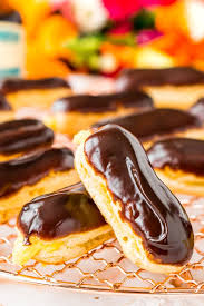 The Eclair Is A Classic French Pastry Traditionally Made With Choux Dough Pastry Cream Filling And Dipped In A Rich Eclair Recipe Easy Eclairs Fancy Desserts