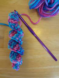 A pair of knitting needles a ball of yarn. Fiber Flux How To Crochet A Curlicue