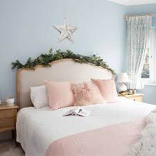 A red knit blanket, plaid bedding. Christmas Bedroom Decorating Ideas That Will Make Your Scheme Look Magical