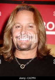 Vince Neil, center, singer for Motley Crue, swings the gavel as the closing  bell is rung as band member Tommy Lee, left, Cathy Kinney, co-president of  the New York Stock Exchange, and