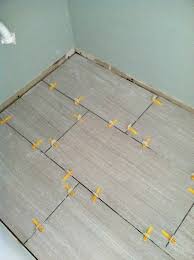 Lay the first large tile in the mortar at the intersection along the two lines. Qep Lash Leveling System With 12x24 Tile Www Involvinghome Com 12x24 Tile Tile Layout Update Small Bathroom