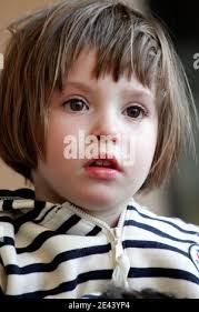 3-year-old daughter Elise as she arrives with her father, Frenchman  Jean-Michel Andre in Marseille, southern France